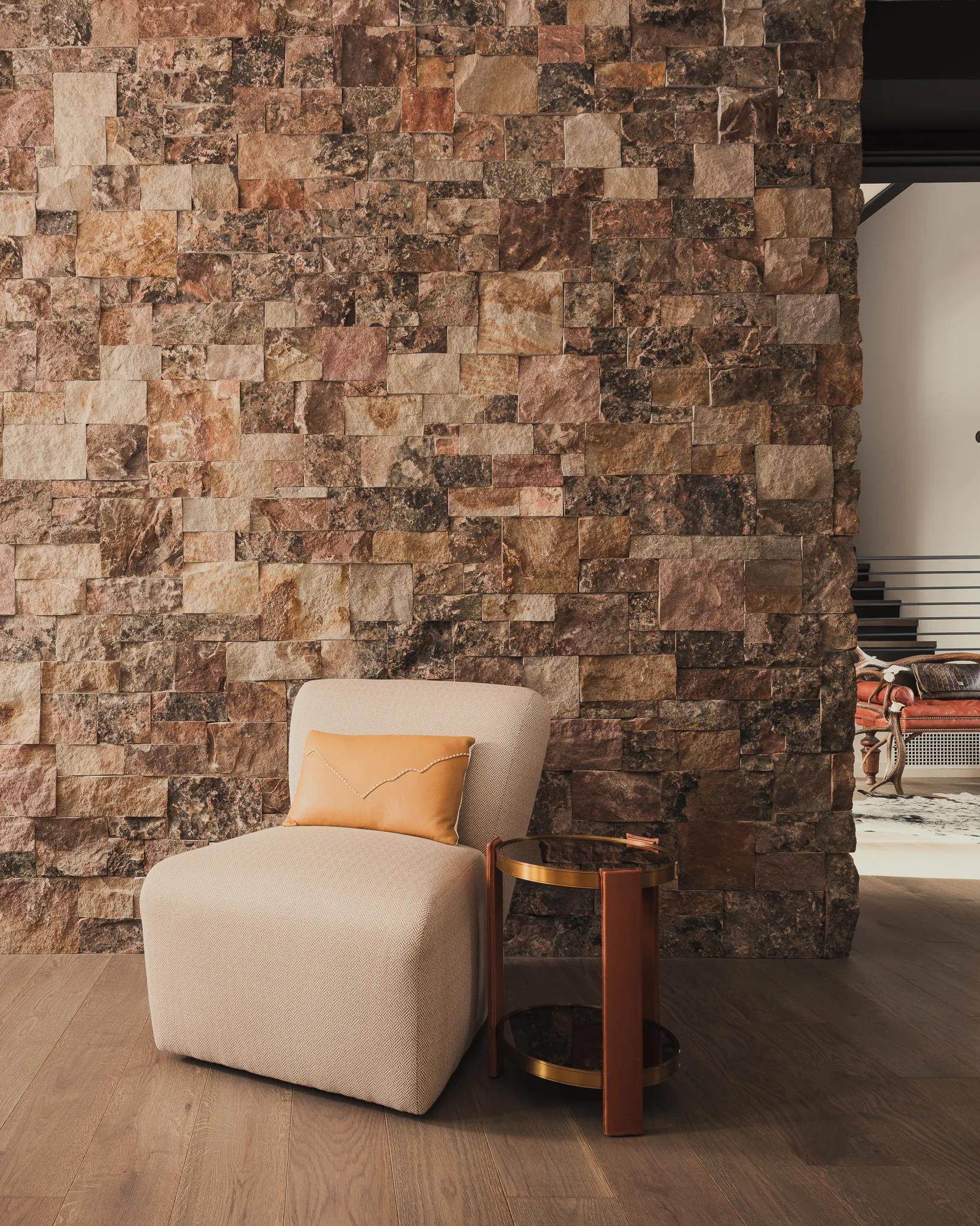 Accent chair styled against a stacked-stone wall — interior design photography Big Sky Montana, Reid Smith Architects